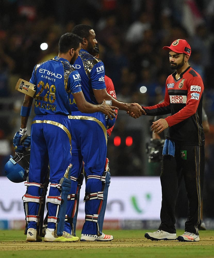 Mumbai Indians players Hardik Pandya and Kieron Pollard being greeted by Rohit Sharma of Royal Challengers Bangalore after the victory during the IPL match in Mumbai.