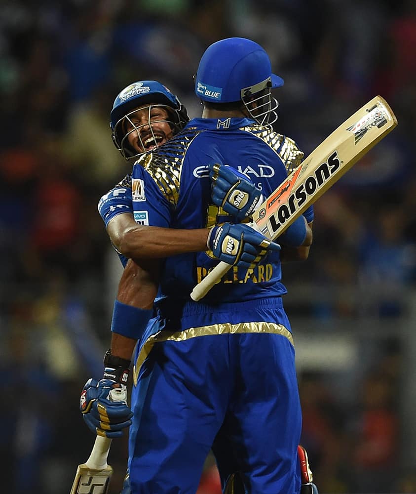 Mumbai Indians players Hardik Pandya and Kieron Pollard celebrate after the victory over Royal Challengers Bangalore during the IPL match in Mumbai.