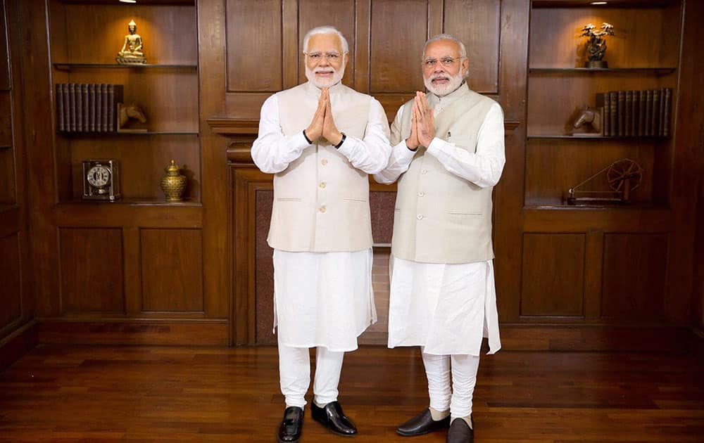 Prime Minster Narendra Modi poses with his wax statue due to be placed at London’s Madame Tussauds museum, in New Delhi. 