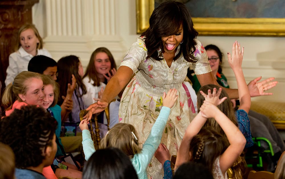 Children clamor to receive hugs from first lady Michelle Obama during the annual White House Take Our Daughters and Sons to Work Day event attended by the children of Executive Office employees, young people from Big Brothers Big Sisters of America, SchoolTalk, and the D.C. Child and Family Services Agency, in the East Room of the White House in Washington