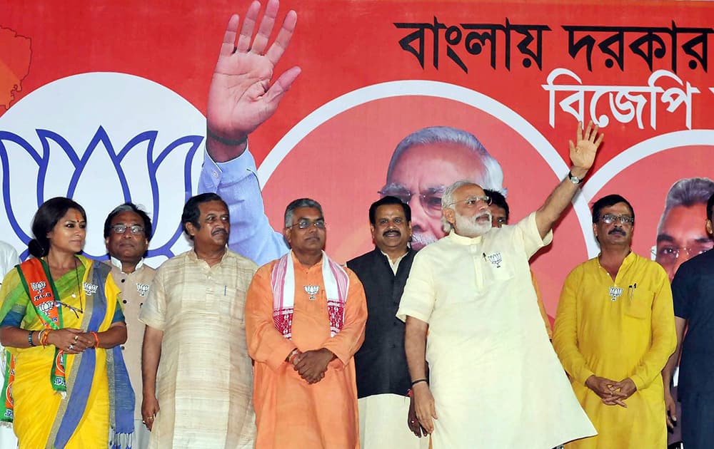 Prime Minister Narendra Modi with actress turned BJP candidate from Howrah-North constituency Rupa Ganguly and others during his election campaign for the West Bengal Assembly polls,in Howrah on Thursday evening.