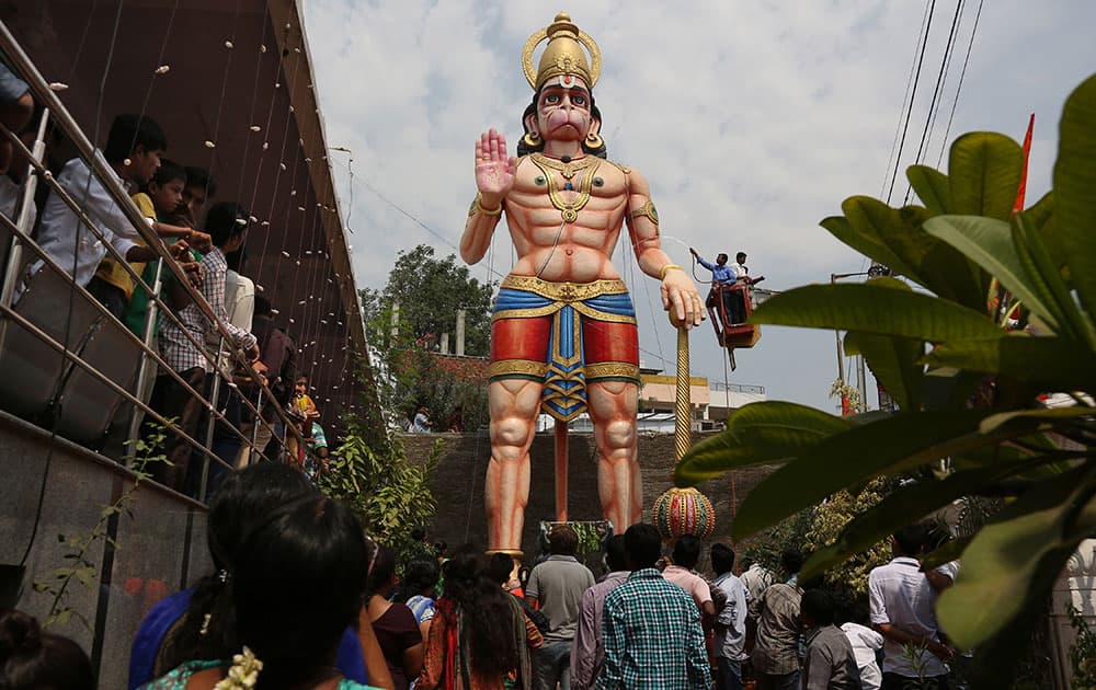 Hindu devotees watch as a 12 meter (40 feet) high statue of Hindu monkey-god Hanuman is washed during Hanuman Jayanti, the birthday of Lord Hanuman in Hyderabad.