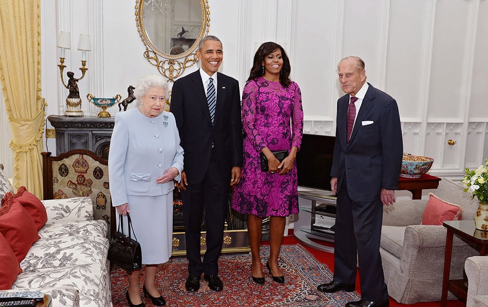 US President Barack Obama and his wife first lady Michelle Obama, pose with Britain's Queen Elizabeth II, left, and Prince Phillip in the Oak room at Windsor Castle ahead of a private lunch hosted by the Queen.