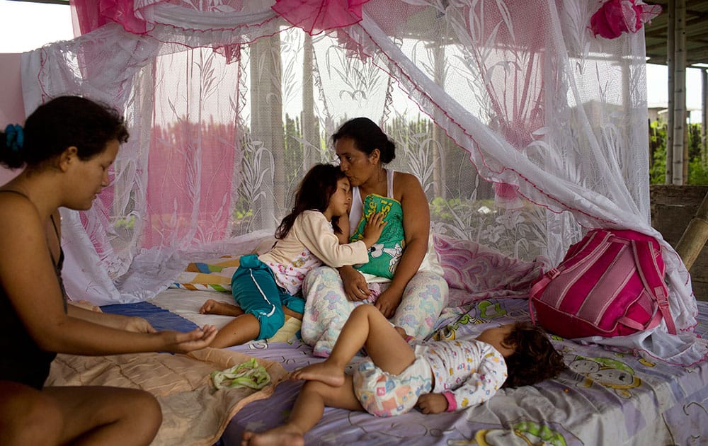 Tais Minga embraces her mother Guadalupe Minga as they wake up inside a building normally used to store small fishing boats, where four families took shelter after loosing their homes in the earthquake in Pedernales, Ecuador.