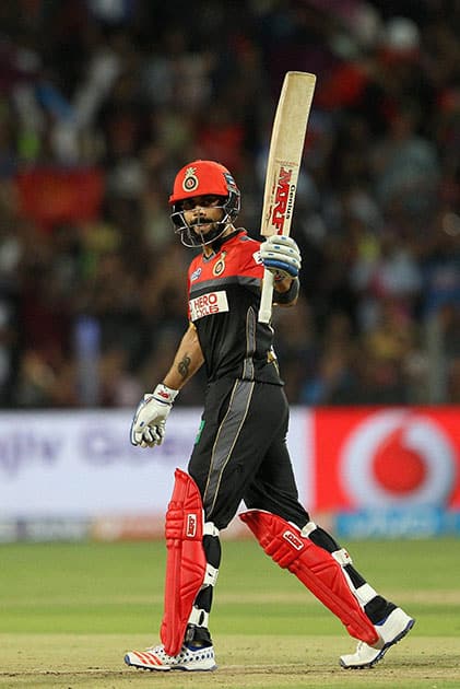 Royal Challengers Bangalore captain Virat Kohli celebrates his fifty against Rising Pune Supergiants during their IPL match at the Maharashtra Cricket Associations International Stadium, Pune.