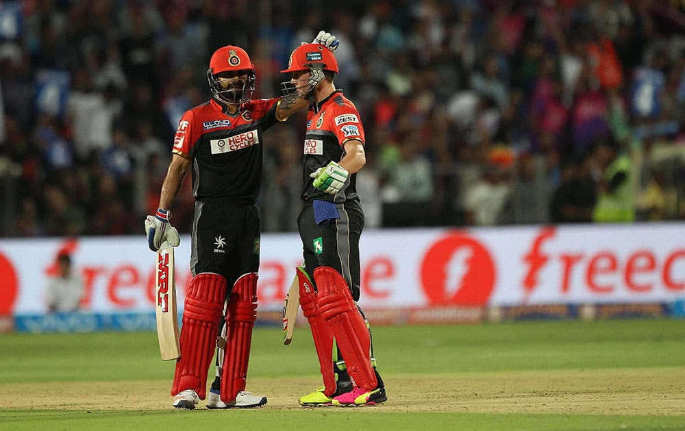 Royal Challengers Bangalore captain Virat Kohli congratulates AB de Villiers of Royal Challengers Bangalore on his fifty against Rising Pune Supergiants during their IPL match at the Maharashtra Cricket Associations International Stadium, Pune.