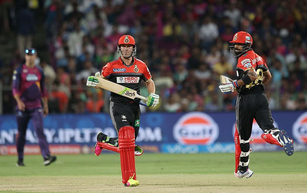 AB de Villiers of Royal Challengers Bangalore and Royal Challengers Bangalore captain Virat Kohli make the runs against Rising Pune Supergiants during their IPL match at the Maharashtra Cricket Associations International Stadium, Pune.