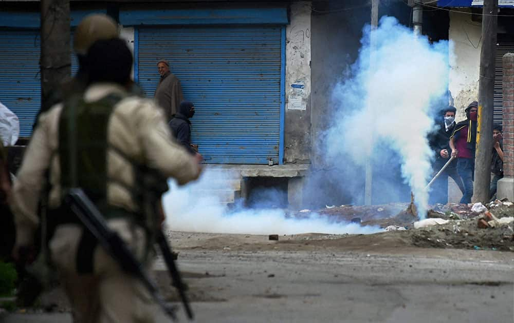 Police fire tear gas shells to disperse a group of youth protesters who were throwing stones on them after clashes erupted when a motorcyclist was thrashed by traffic cops during a scuffle, at Batamaloo area in Srinagar.