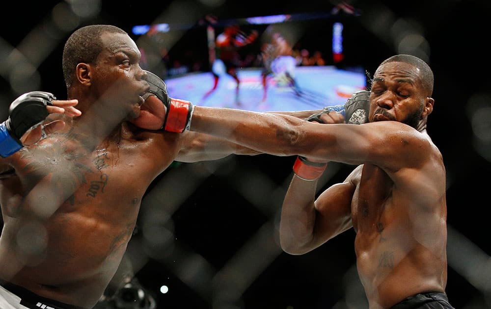 Ovince Saint Preux, left, and Jon Jones trade blows during an interim light heavyweight championship mixed martial arts bout at UFC 197 in Las Vegas. 