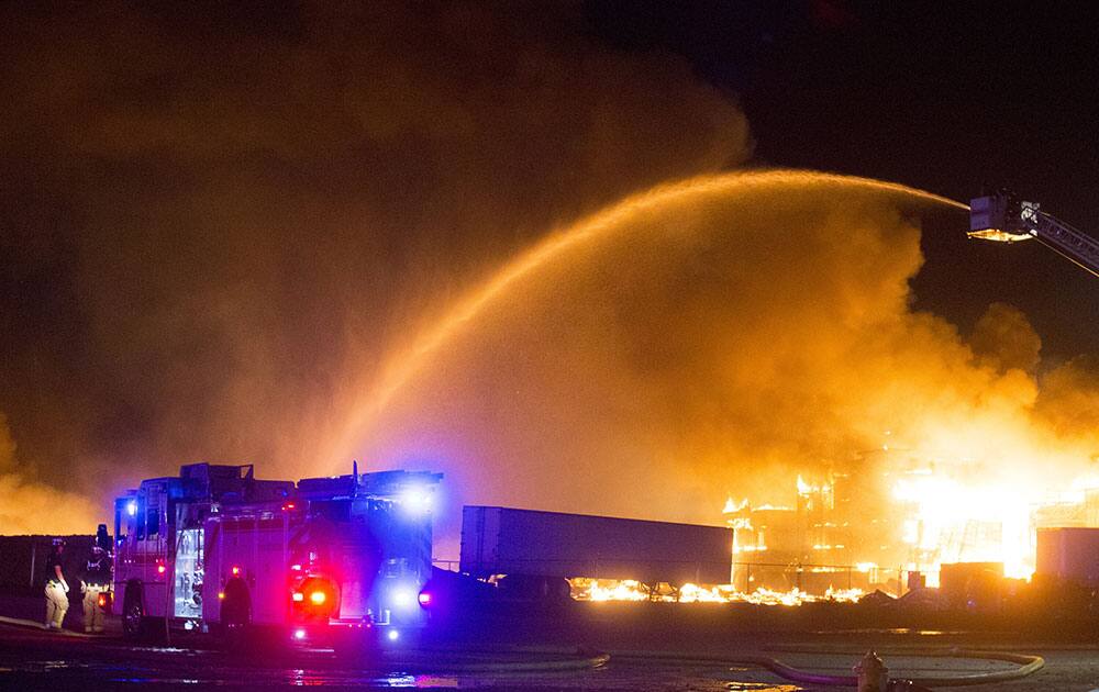 Fire crews battle a blaze in the Phoenix suburb of Gilbert, Ariz.