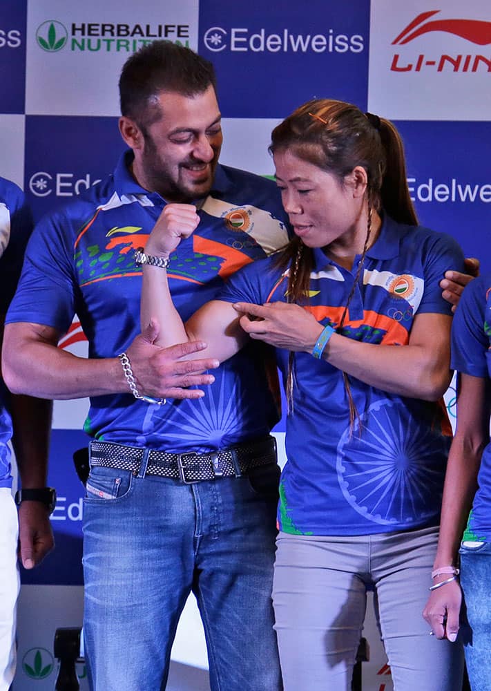 Indian boxer Mary Kom, right, playfully flexes her biceps to tease Bollywood actor Salman Khan, left, at an event to announce Khan as the goodwill ambassador for Rio Olympics 2016 in New Delhi, India.