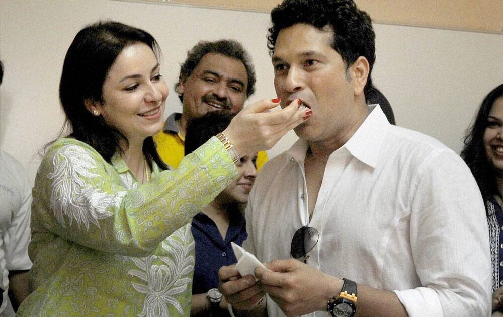 Master blaster Sachin Tendulkar is offered cake by his wife Anjali during his 43th birthday celebration with children from the Make-A-Wish India organisation in Mumbai.