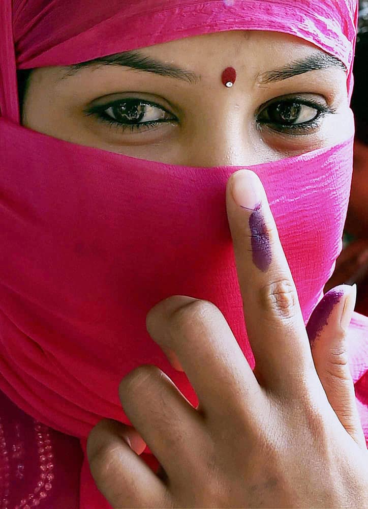 A woman shows her ink marked finger after casting vote during 4th phase of state assembly polls.