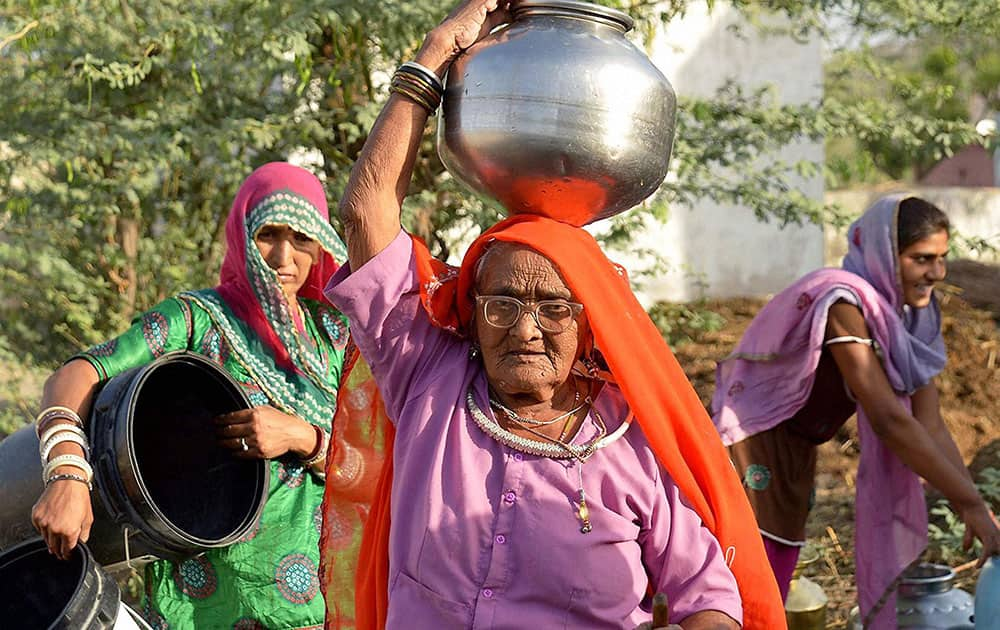 Women carrying water in a village hit by contaminated drinking water in Ajmer.