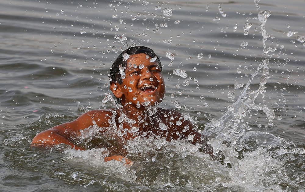 A boy bathes in the River Sabarmati on a hot day in Ahmadabad.