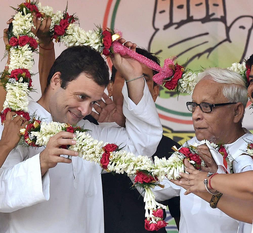 Congress Vice President Rahul Gandhi and former West Bengal Chief Minister and CPI(M) leader Buddhadeb Bhattacharjee being garlanded at a joint election campaign rally in Kolkata.