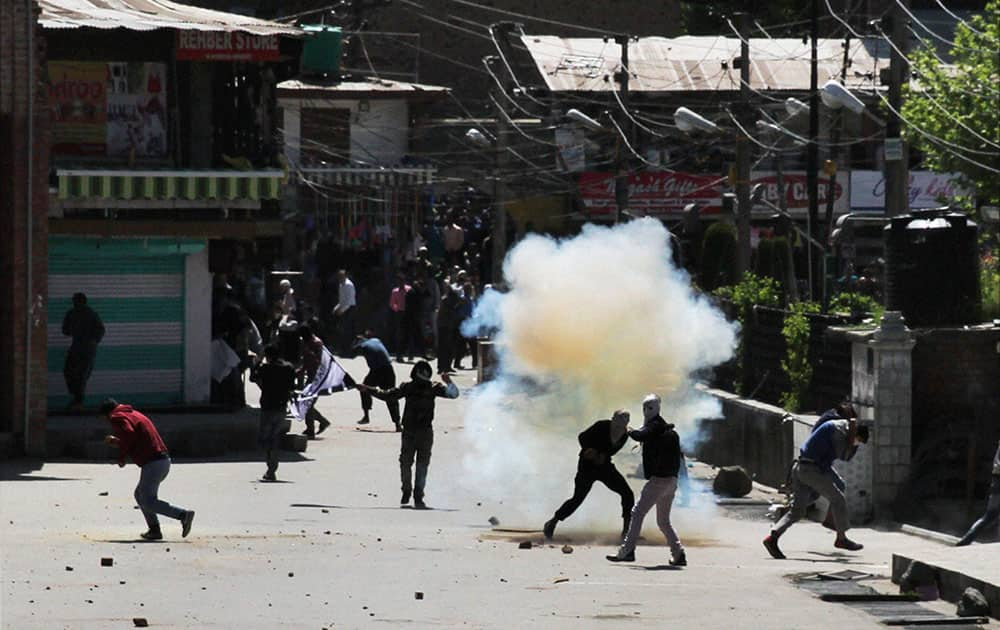 Protesters throw stones on security personnel during clashes in Srinagar.