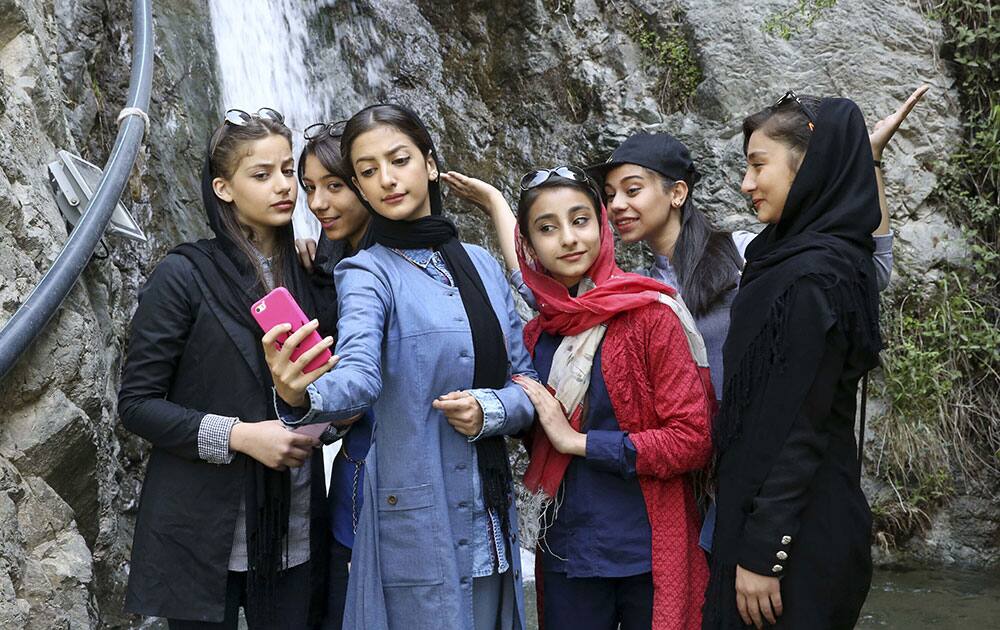 Iranian teenagers take selfie while enjoying their time at the Tochal mountainous area northern Tehran, Iran.