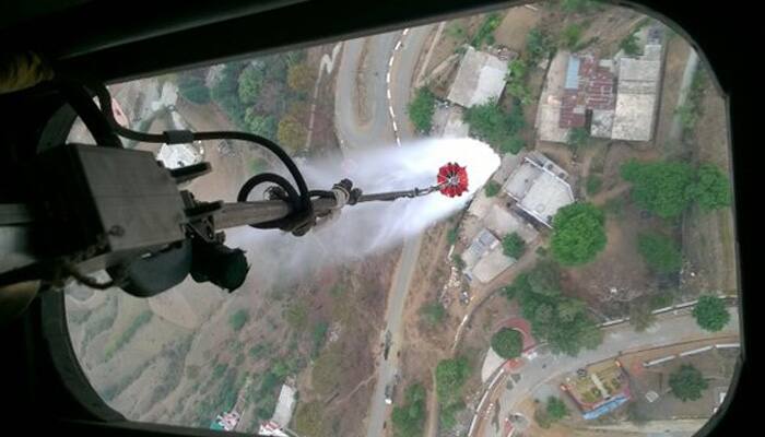 IAF chopper sprinkles water to douse Uttarakhand​ forest fires; Rajnath Singh reviews situation
