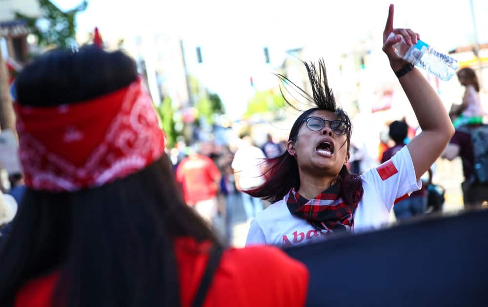 People participate in a march for immigrant and worker rights in Seattle. 