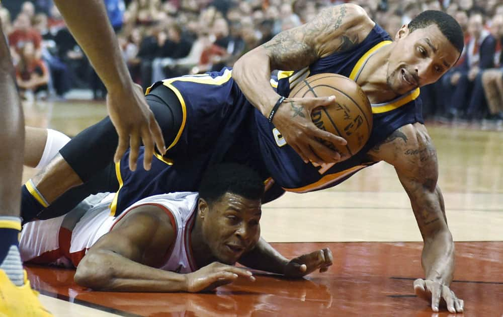 Toronto Raptors guard Kyle Lowry, bottom left, and Indiana Pacers guard George Hill (3) battle for the ball during Game 7 of round one NBA playoff basketball action in Toronto.