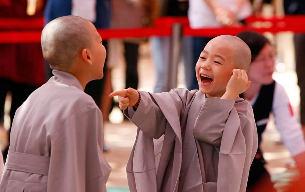 Two boys smiles after having their heads shaved during a service to celebrate Buddha's upcoming 2,560th birthday on May 14, at the Jogye Temple in Seoul, South Korea.