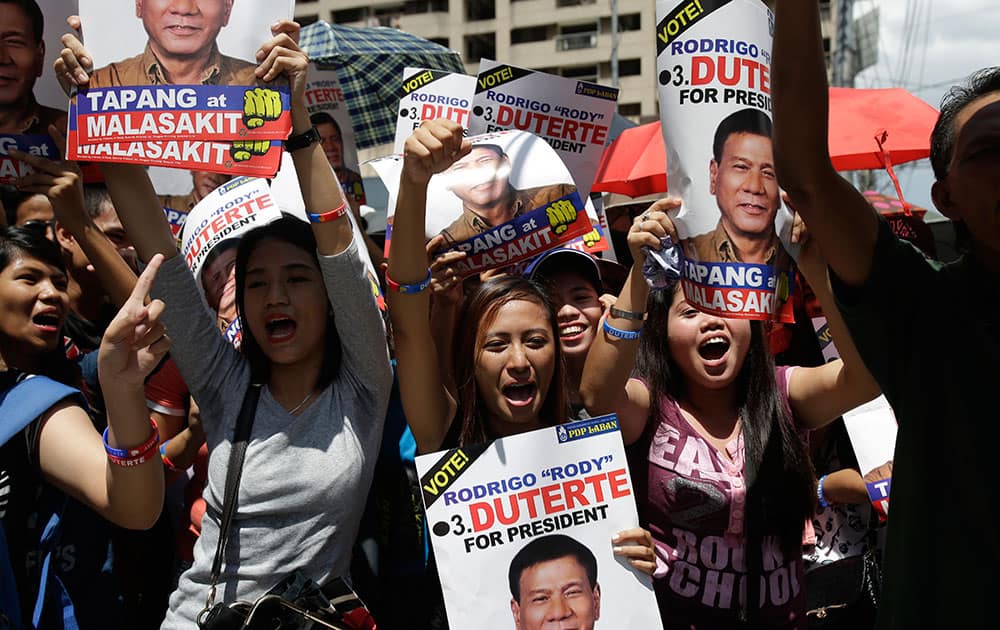 Supporters of Philippine presidential candidate Rodrigo Duterte shouts slogans as they wait outside a bank in Pasig, east of Manila, Philippines.