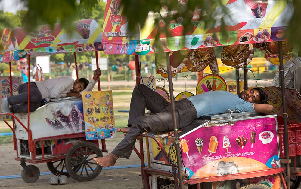 Ice cream vendors rest on their carts on a hot afternoon in New Delhi. Much of India is reeling under a weekslong heat wave and severe drought conditions that have decimated crops, killed livestock and left at least 330 million Indians without enough water for their daily needs.