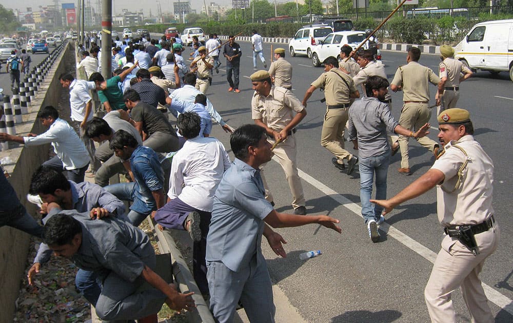 Police lathicharge agitating taxi drivers during their protest over ban on diesel vehicles, at Delhi-Gurgaon Expressway in Gurgaon.