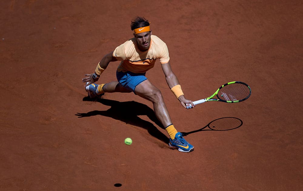 Rafael Nadal, from Spain, lunges to return a ball against Andrey Kuznetsov, from Russia, during a Madrid Open tennis tournament match in Madrid, Spain.