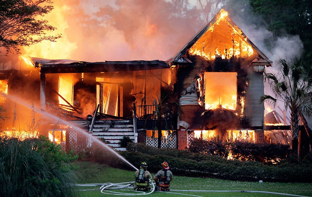 St. Tammany firefighters battle a house fire in Flowers Estates North Subdivision between Covington and Madisonville.