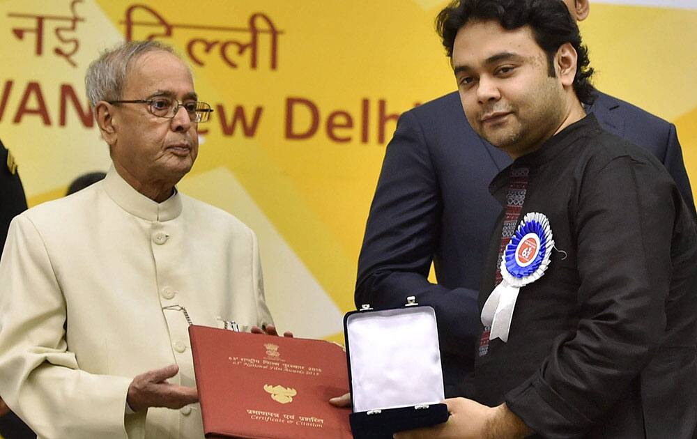 President Pranab Mukherjee presents Best Hindi Film award to films director Maneesh Sharma for Dum laga ke haisha at the 63rd National Film Awards 2015 function in New Delhi.