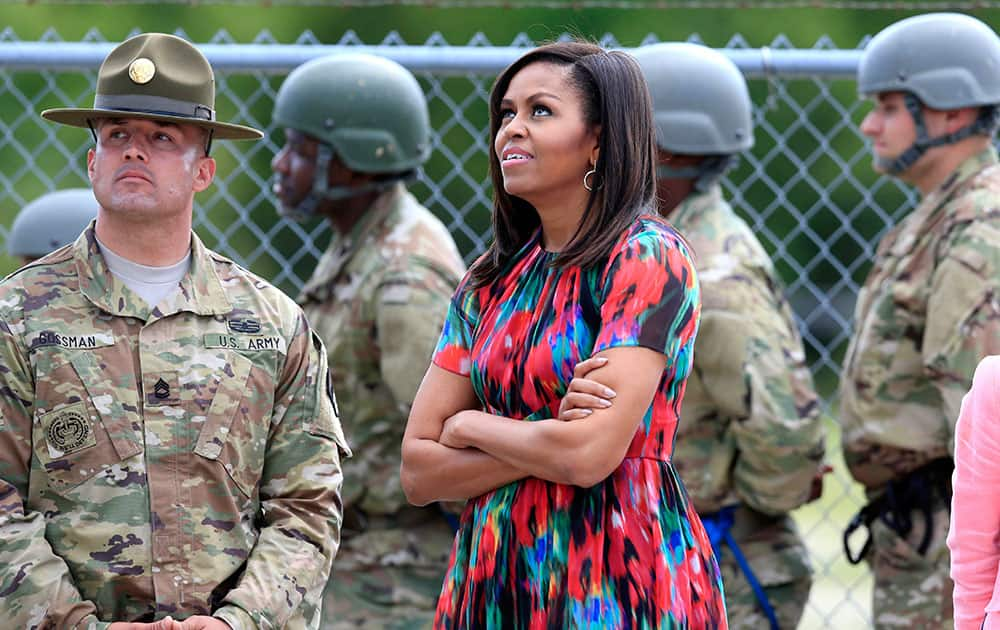 First lady Michelle Obama looks up at the Warrior Tower where soldiers learn to rappel while visiting Fort Leonard Wood, Mo.