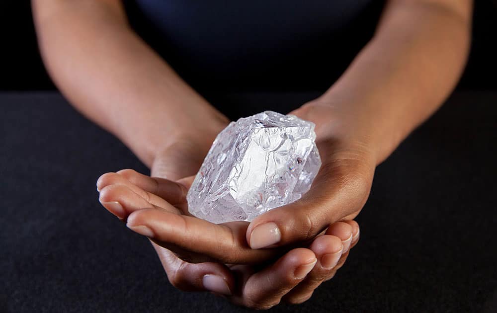 A Sotherby's employee holds Lesedi La Rona Diamond in New York City. The diamond the size of a tennis ball that is the largest discovered in more than a century could sell at auction for more than $70 million.