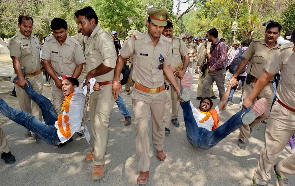 Policemen detain students who were staging a hunger strike in protest over entrance exams for admission to various courses at Allahabad University.