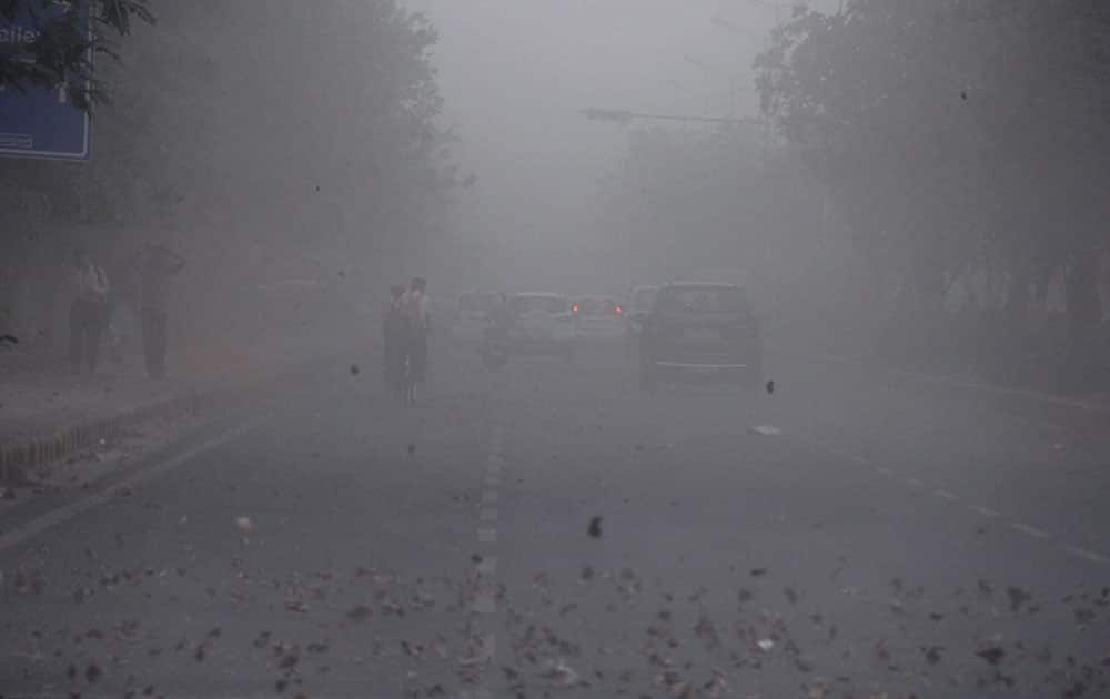 A scene at a road after a sand storm in Gurgaon.