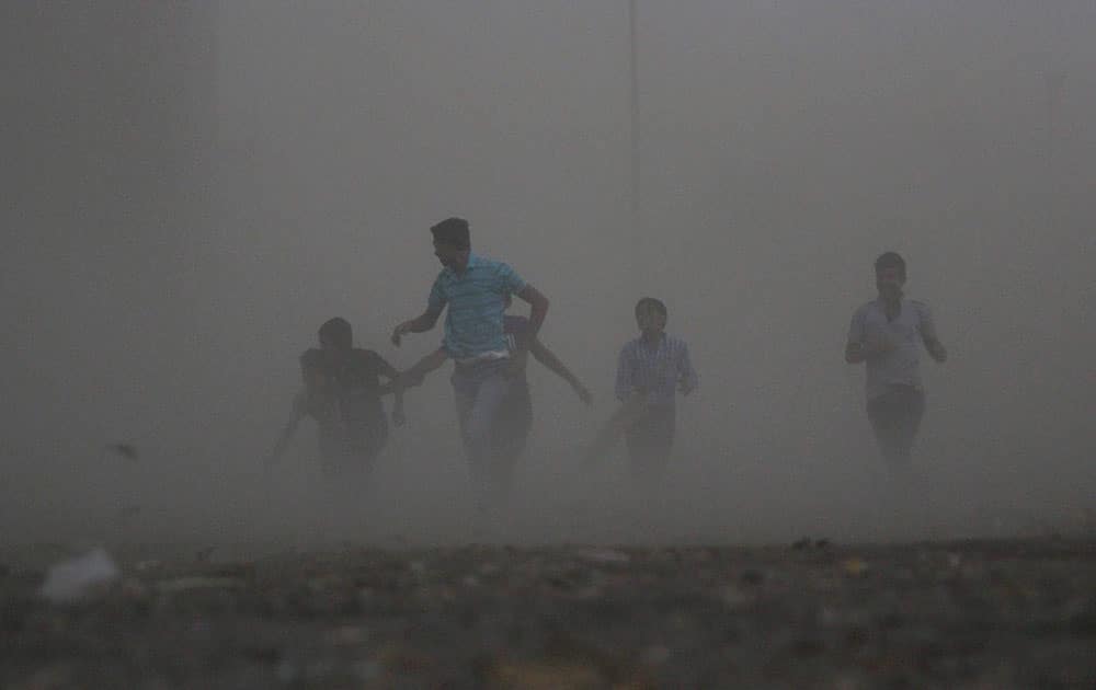 Children caught in strong wind on the outskirts of Nagpur.