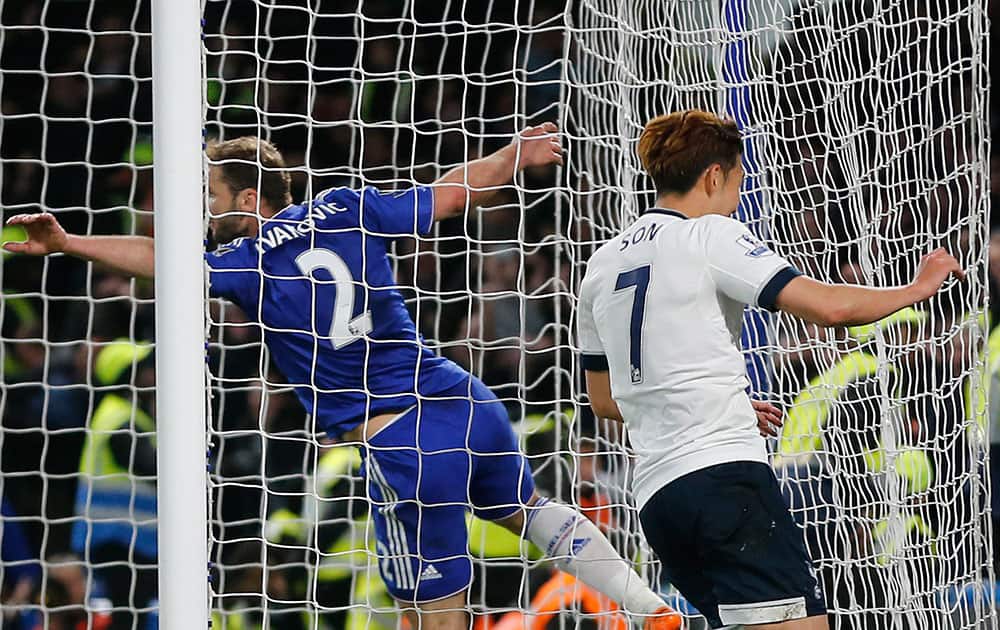 Tottenham's Son Heung-min, right, celebrates after he scores a goal during the English Premier League soccer match between Chelsea and Tottenham Hotspur at Stamford Bridge stadium.