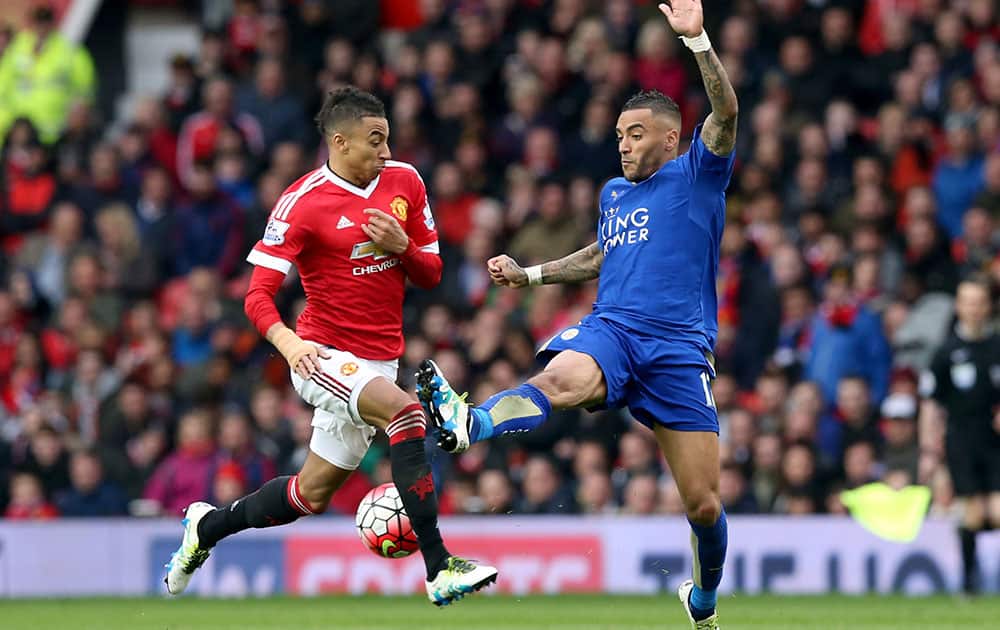 Manchester United's Jesse Lingard, left, and Leicester City's Danny Simpson in action during their English Premier League soccer match at Old Trafford.