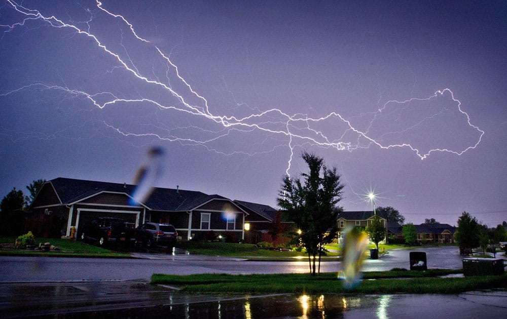 Lightning strikes across the sky above homes in south Walla Walla, Wash.