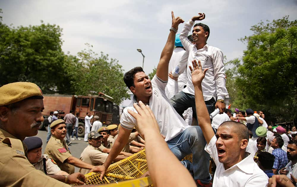 Supporters of India's opposition Congress party shout slogans as they try to break through police barricades while marching towards Indian Parliament during a protest against the ruling Bharatiya Janata Party (BJP) government in New Delhi. 