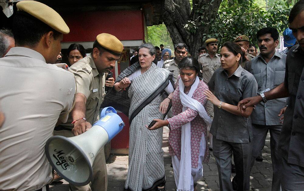 India's opposition Congress party president Sonia Gandhi is escorted by her security personnel as she leads a march against the ruling Bharatiya Janata Party (BJP) government in New Delhi. 