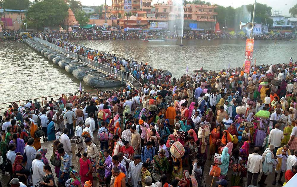 Devotees gather to take holy dip in River Kshipra during Simhastha Maha Kumbh Mela in Ujjain, a day after thunderstorm and heavy rains.
