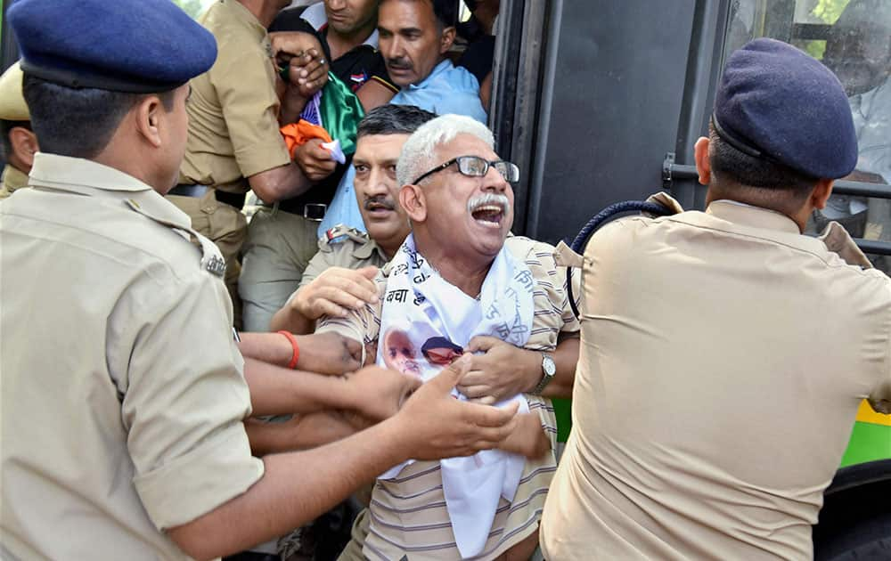 Police preventing Aam Aadmi Party supporters to hold a protest over AgustaWestland scam, at Race Course metro station near PM house in Delhi.