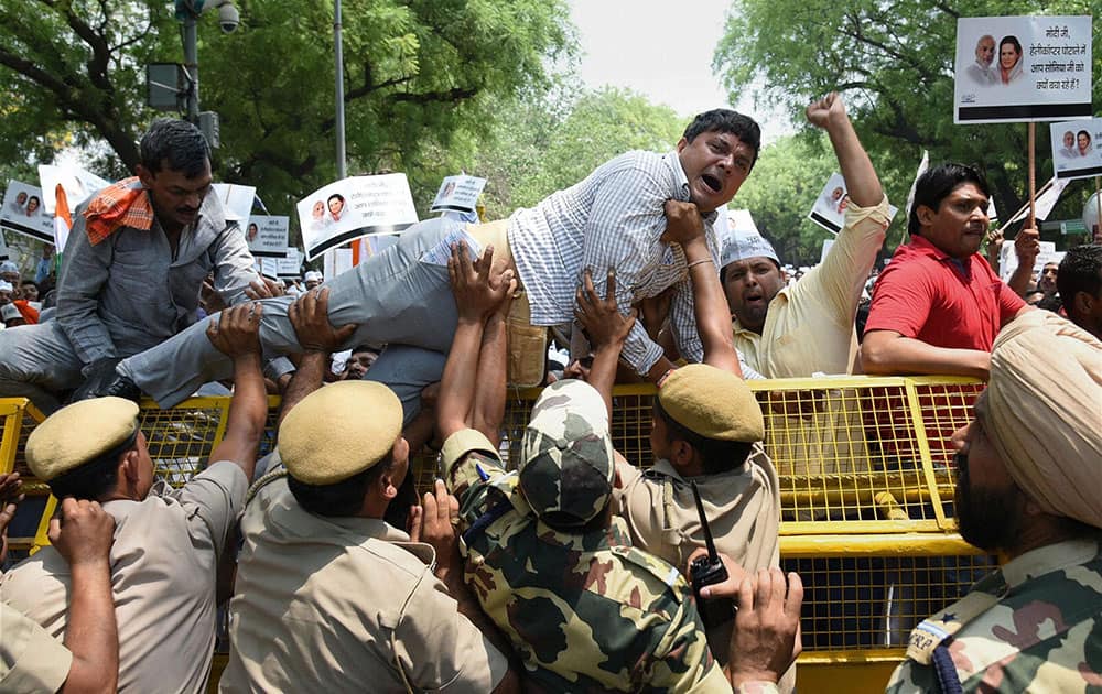 Aam Aadmi Party workers defying police restrictions during a protest against Agustawestland scam at Jantar Mantar in New Delhi.