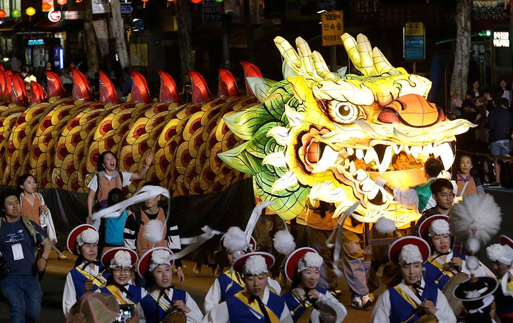 Buddhists carry a giant lantern in a parade during the Lotus Lantern Festival to celebrate the upcoming birthday of Buddha on May 14, on a street in Seoul, South Korea.