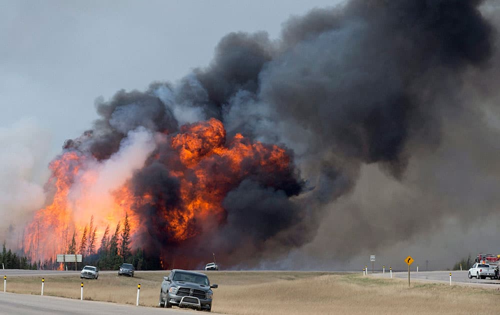 A wildfire burns south of Fort McMurray, Alberta, near Highway 63.
