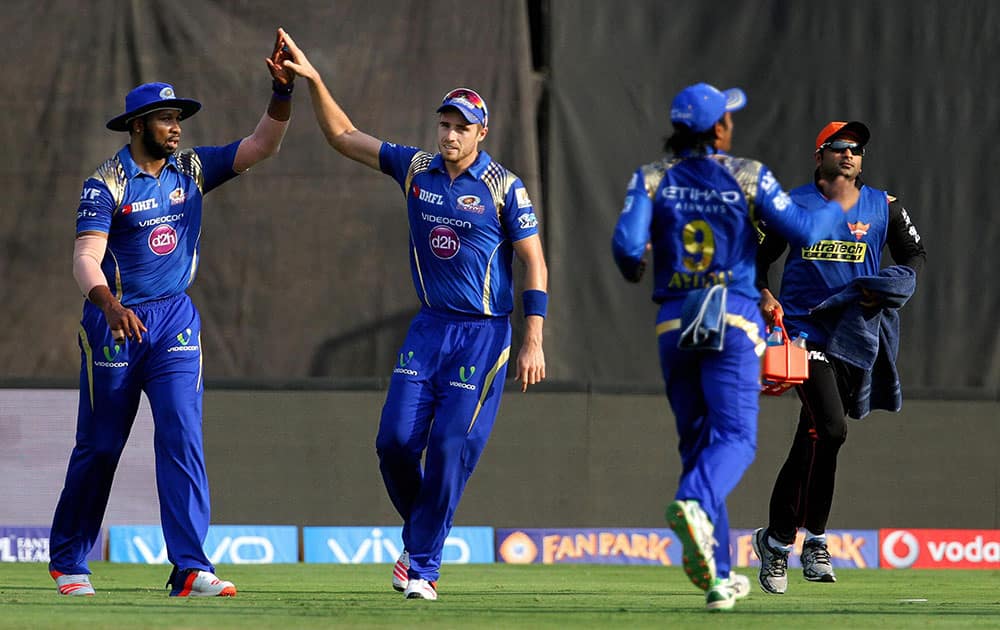 Mumbai Indians players celebrate the wicket of Sunrisers Hyderabad captain David Warner their IPL match in Visakhapatnam.