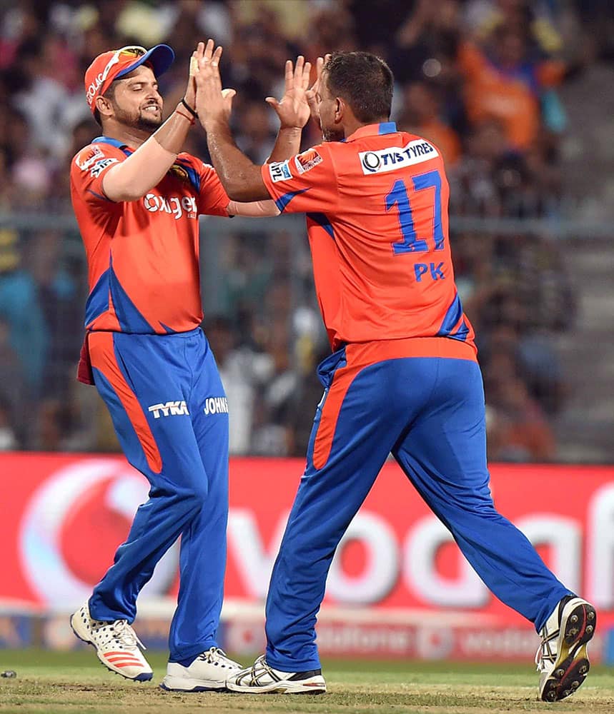 Gujarat Lions bowler Praveen Kumar celebrate with Captain Suresh Raina after the wicket of KKR Captain Gautam Gambhir at Eden Garden in Kolkata.