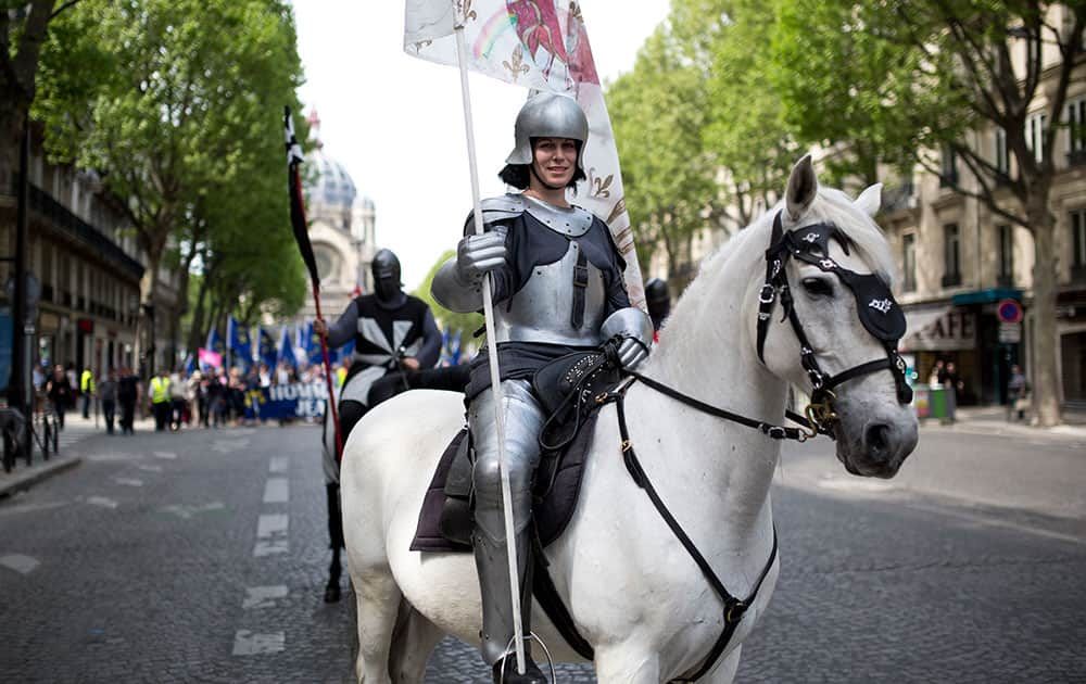 A woman dressed as Joan of Arc sits on a horse during a demonstration commemorating Saint Joan of Arc organized by the fundamentalist Catholic-nationalist Civitas institute in Paris, France.